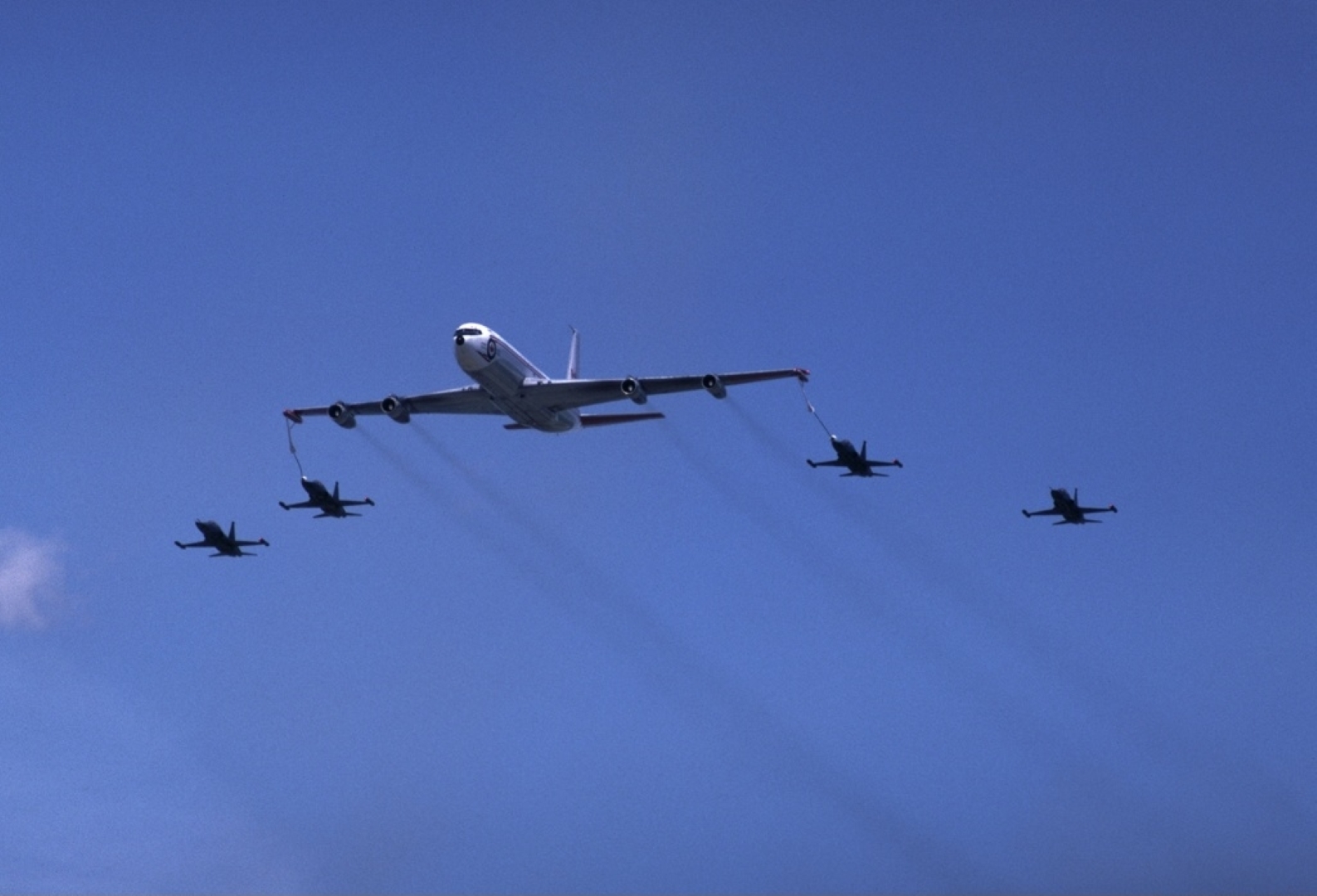 Canadian Armed Forces Boeing 707 (CC-137) with 4 Canadian Armed Forces CF-5 Freedom Fighters (CF-116) during the Canadian International Air Show at the CNE over Toronto, Ontario, Canada.